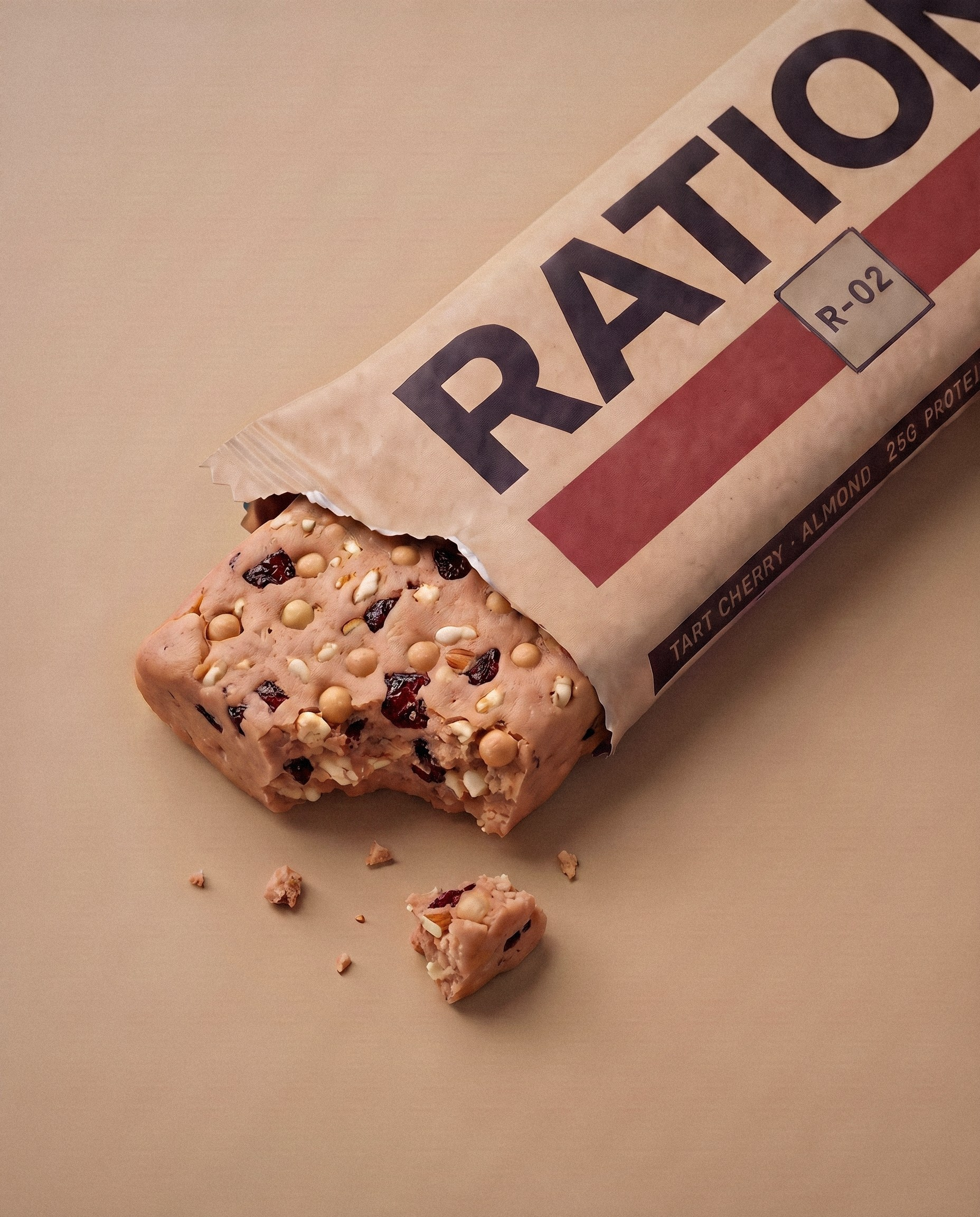 Studio render of the R-02 Tart Cherry · Almond bar in its printed wrapper.